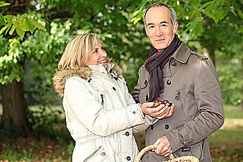 Couple gathering conkers