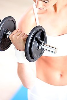 woman lifting weight in sports room