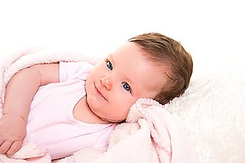 baby girl smiling dress in pink with winter white fur background