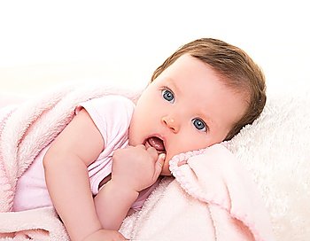 baby girl with toothache in pink with winter white fur background