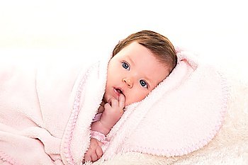 baby girl with toothache in pink with winter white fur background
