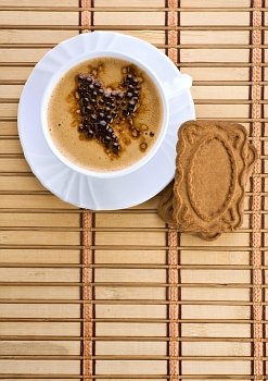 blue mug with espresso coffee with Cookies on a wum mat