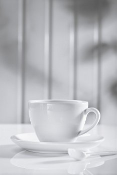 ceramic coffee cup with spoon on white