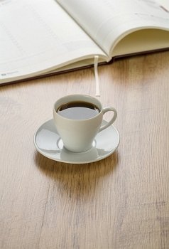 diary with cup of coffee