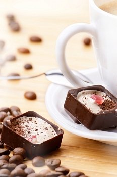 Coffee cup and milk chocolate candy closeup