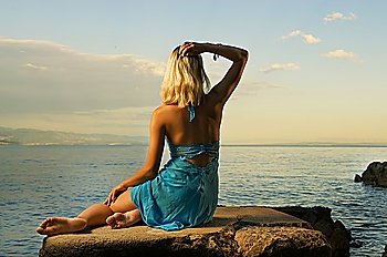 Beautiful woman relaxing near the sea