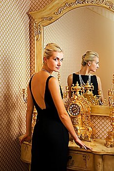 Beautiful blonde girl near luxury the mirror