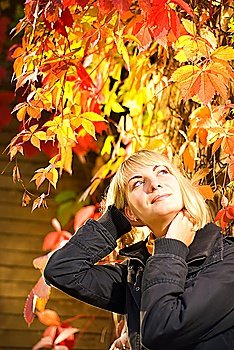Young blond girl on autumn background