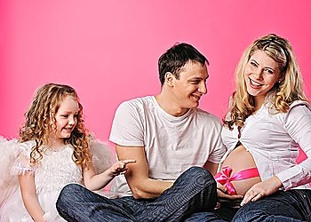 Portrait of a happy young family expecting a baby