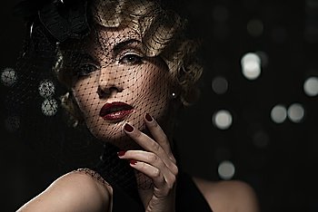 Elegant blond retro woman  with red lipstick wearing little hat with veil