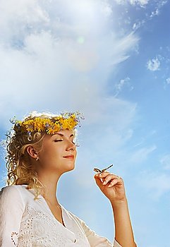 Lovely woman with a butterfly over blue sky