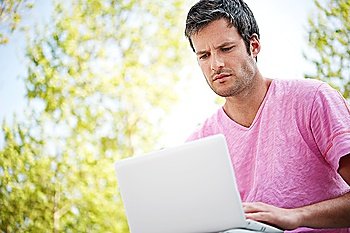 Handsome man with laptop outdoors