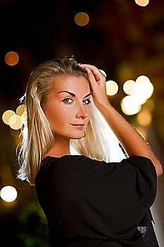 Young blond woman outdoors. Close-up portrait