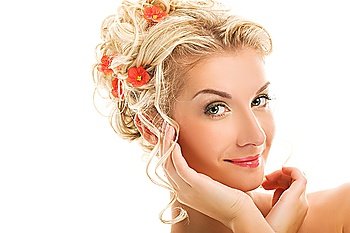 Beautiful young woman with fresh flowers in her hair. Spring concept.