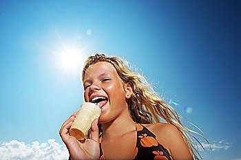 Happy girl eating icecream outdoors
