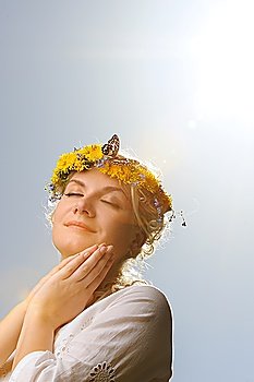 Lovely woman with a butterfly over blue sky