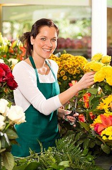 Cheerful woman flower shop market choosing working colorful market