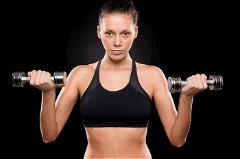 Portrait of a sporty woman lifting weights with both hands
