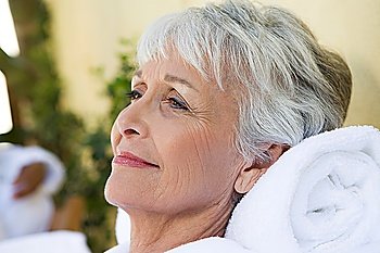 Senior woman relaxing at health spa