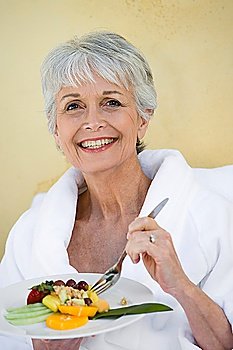 Portrait of senior woman eating healthily