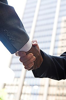 Close-up of businessmen handshake, outdoors
