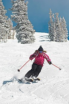 Teenage Girl Skiing Down a Slope