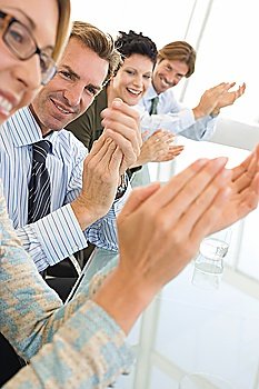 Business colleagues applauding in conference meeting