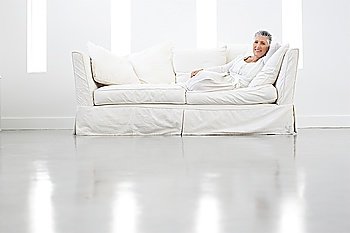 Woman Relaxing on White Sofa