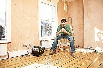 Man Taking a Break While Renovating Room
