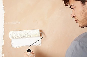 Man Painting Wall with Roller