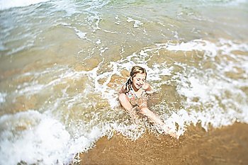 Girl playing in surf elevated view