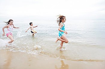 Children running in surf