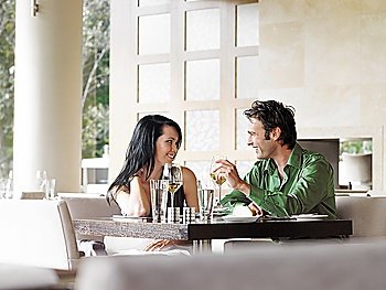 Couple talking over wine at outdoor restaurant