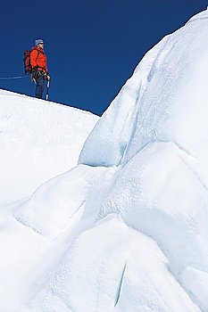 Mountain climber hiking past ice formation