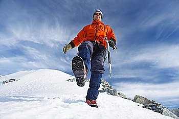 Mountain climber hiking on snowy slope