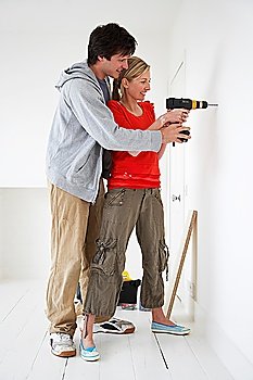 Couple drilling inside their new home
