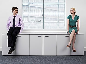 Businesspeople Sitting on Cabinets