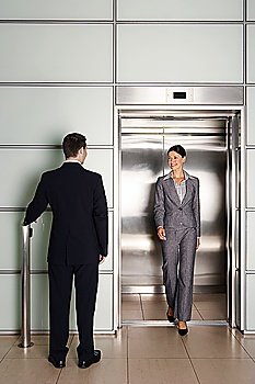 Businesspeople Using Office Elevator