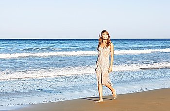 Young Woman Walking Along Beach