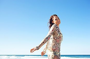 Young Woman in Floral Wrap at Beach