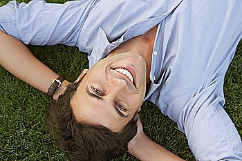 Smiling Businessman Lying Down on Grass