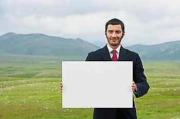 Businessman Outdoors Holding Blank Sign