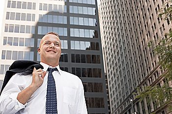 Businessman outside office building smiling