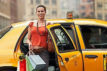 Woman Stepping Out of Taxi Cab with Shopping Bags