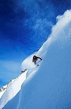Snowboarder on steep slope