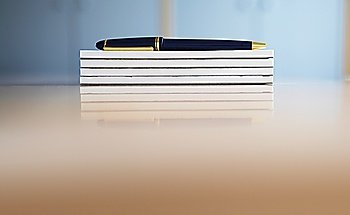 Stack of Notepads and a Pen