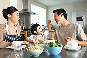 Young Family Having a Meal in Kitchen