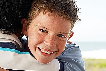 Close-up of Boy Hugging Father