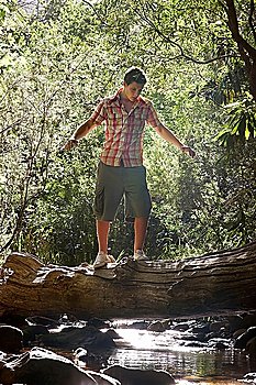 Young Man Balancing on Log