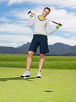 Young Golfer Standing on Green
